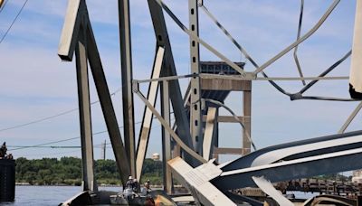 Crew remove large piece of steel from channel at Francis Scott Key Bridge collapse site