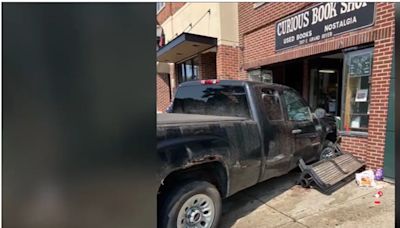 Car crashes into bench near Curious Book Store, driver flees the scene