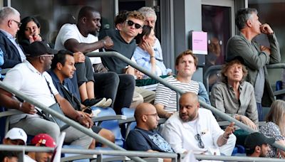 Swimming Rock Star Léon Marchand, Actual Rock Star Mick Jagger Take in Olympic Track