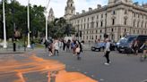 Just Stop Oil activists arrested as they cover Parliament Square in orange paint