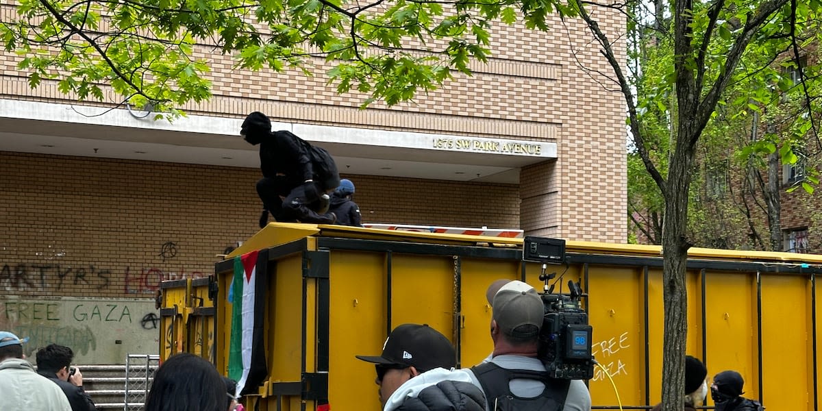 Police arrest 8 more after protesters rip down barricades, break into PSU library again