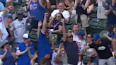 A Cubs fan somehow snagged a foul ball with one hand while holding a child