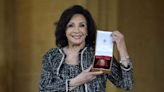 Dame Shirley Bassey breaks protocol and says 'I grabbed him' after receiving Royal honour from King Charles