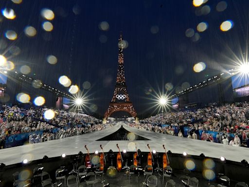 AP PHOTOS: Paris glitters in the rain for ambitious Olympic opening ceremony