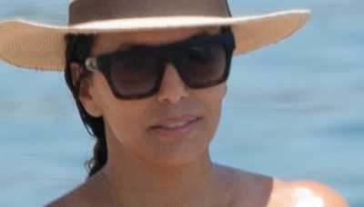 Eva Longoria, 49, works on her tan in a tiny rainbow bikini