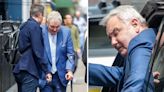 Eamonn Holmes grimaces using crutches to aid him after health problems