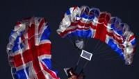 Actors imitating Britain's late Queen Elizabeth II and James Bond parachute into the stadium during the opening ceremony of the London Olympics