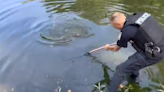 Officer helps boy net giant carp that took 15 minutes to catch