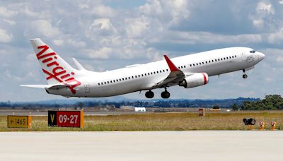 Australian police arrest a man accused of running naked through an airliner