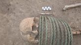 Skeletons with buckets on their feet and rings around their necks discovered in a Dark Ages graveyard, say reports