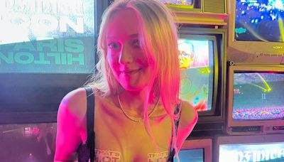 Dakota Fanning wears 'that's hot' stickers over cleavage