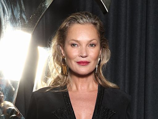 Kate Moss wears an elegant sheer gown at YSL's Paris Fashion Week show