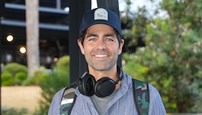 Adrian Grenier is all smiles as he touches down in Sydney