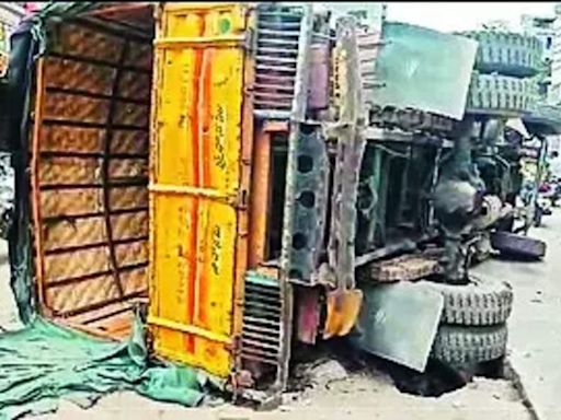 City road caves in as truck falls over | Hyderabad News - Times of India