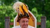 Sporting a feathered headdress, Pope Francis finds 'Eden' in Papua New Guinea