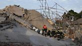 Rescuers contact some workers alive in the rubble of a deadly building collapse in South Africa