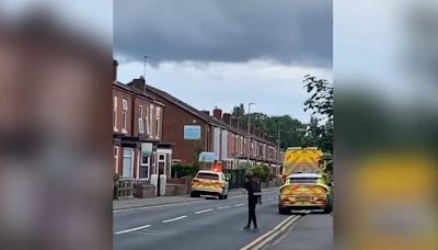 Suspect arrested and led away in handcuffs after police 'swarm' Salford street