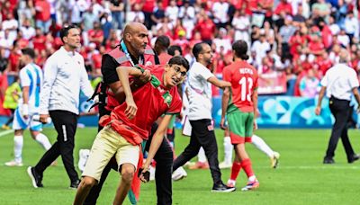 Olympic football off to violent, chaotic start as Morocco fans rush the field in team's stunning win over Argentina