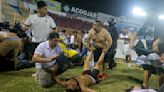 Angry fans crash through gate at El Salvador soccer match in stampede that kills 12, injures dozens