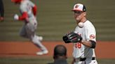 Baltimore Orioles starter Tyler Wells, right, gets a new game ball from umpire Ramon DeJesus after giving up a two-run homer to Los Angeles Angels’ Taylor Ward, left, in the first inning on...