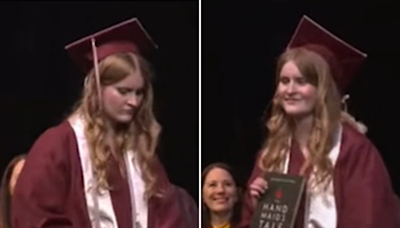 Footage shows moment student pulls out banned book at her graduation