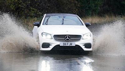 How should I drive if I get caught in a thunderstorm?