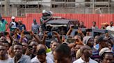 Nigeria election: Crowds chant 'let us vote' after unexplained delays at polling units as they queue to choose new president