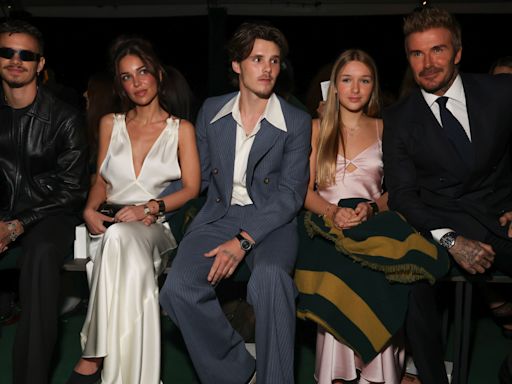 Victoria Beckham supported by family at Paris Fashion Week show