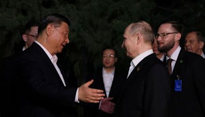 Hugs but not the full socialist-era kiss for Putin, Xi in Beijing