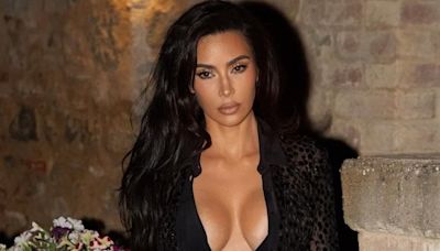 Kim Kardashian shows off her hourglass curves in a skimpy black bikini