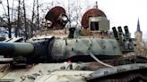 Russians place flowers at burnt out tanks in Baltic cities