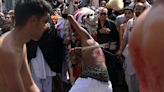 Shi'ite Muslim devotees whip themselves with sharp blades