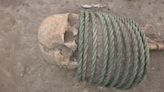 Skeletons found in 1,000-year-old grave with rings around neck and buckets on feet