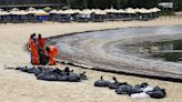 Singapore intensifies oil spill clean up after it spreads along coast