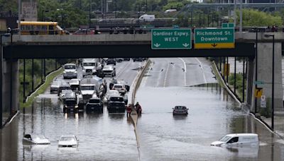 A major highway and roads are flooded as torrential rains hit Canada’s largest city