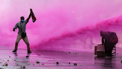 Flames engulf parliament as police 'shoot dead' five protesters