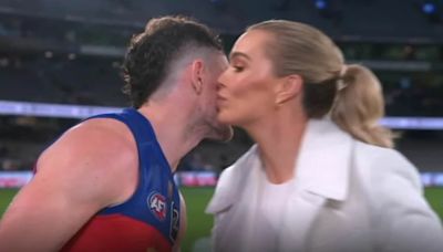 AFL kiss between TV host and footy legend sparks furore