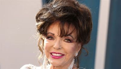 Joan Collins, 90, shows off unbelievable legs in a daring black halterneck swimsuit