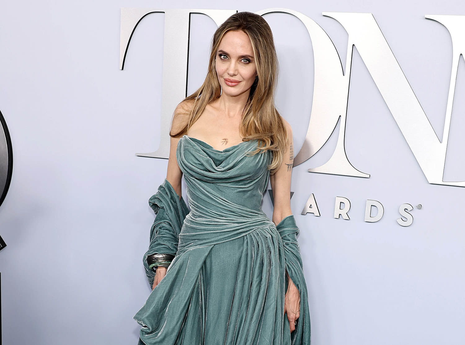 Angelina Jolie reveals new chest tattoo at Tony Awards
