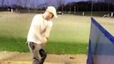 guy hits ball at the range and hits something which sets off alarm