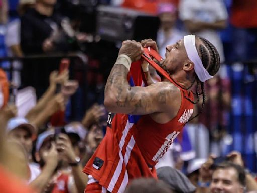 Jose Alvarado celebrated Puerto Rico's Olympics-clinching win by jumping onto scorer's table