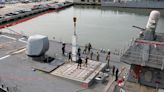 Reloading vertical missile tubes at sea is within a crane arm’s reach