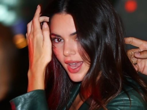 Kendall Jenner puts on a leggy display in a green leather mini skirt