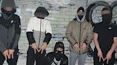 Wannabe gangster poses with group of masked friends holding weapons