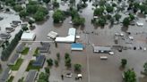 Rail bridge collapses during Midwest flooding as a heat wave persists across much of the US