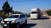 Days after quake, aid trucks reach northwest Syrian enclave