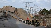 Rescuers bring out survivors from the rubble a day after a deadly building collapse in South Africa