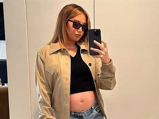 Ashley Tisdale displays her baby bump in a crop top and 'the only jeans that will fit me right now' as she expects her 2nd child with Christopher French