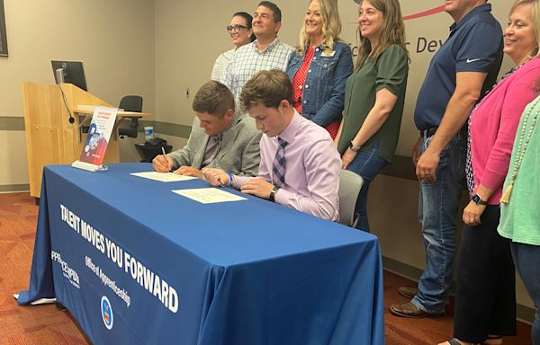 Four Columbia high school students sign as registered youth apprentices with businesses