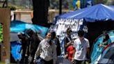 People walk inside a pro-Palestinian protest encampment on the campus of the University of California, Los Angeles (UCLA) in Los Angeles, California, on May 1, 2024